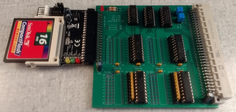 Square green PCB with components, and a Compact Flash card connected via an IDE adapter